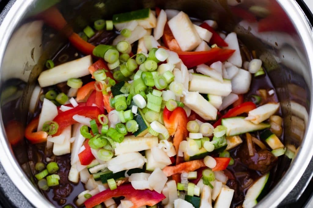 Adding all the veggies to the Asian Instant Pot recipe