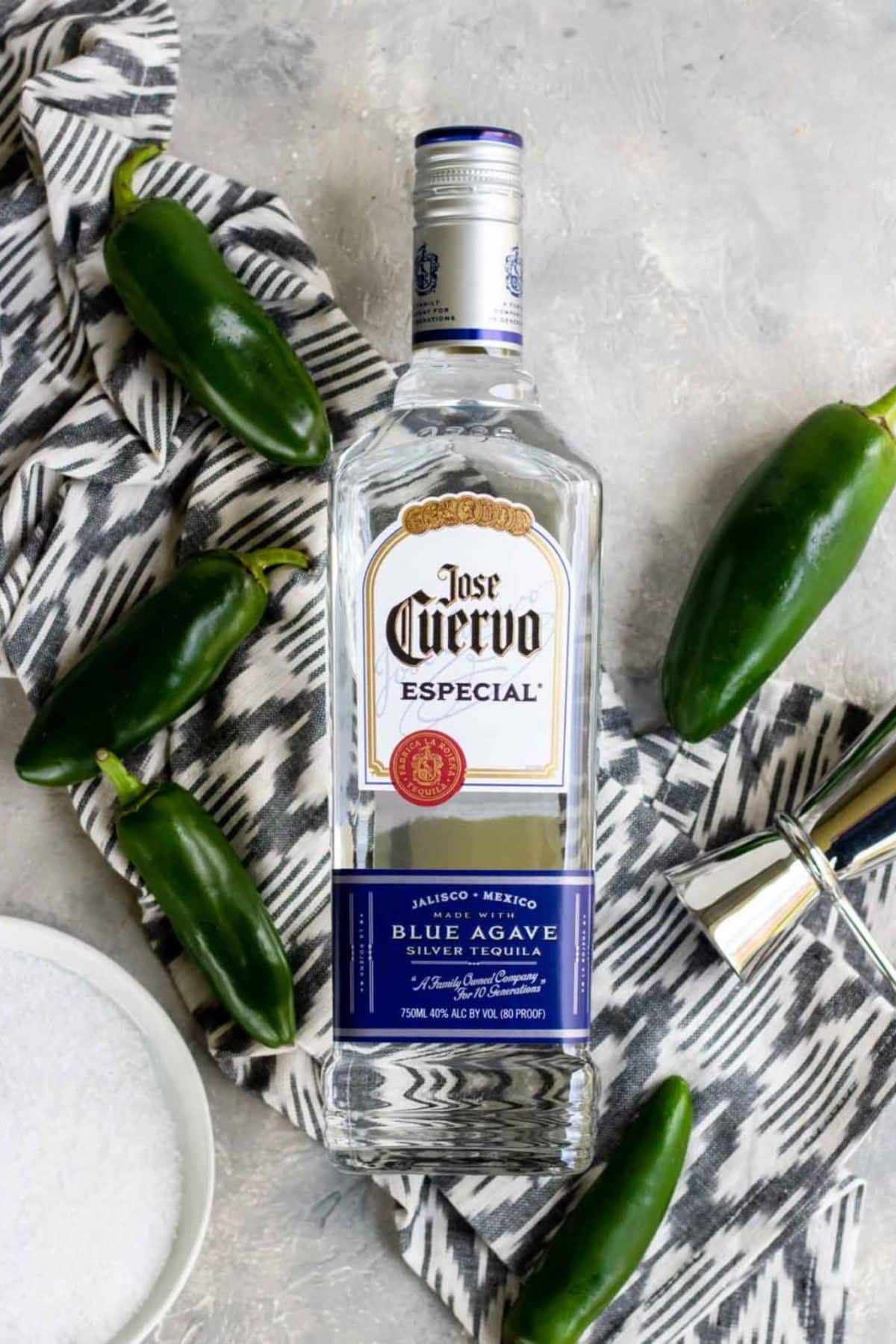 a bottle of silver tequila with jalapenos around the edge