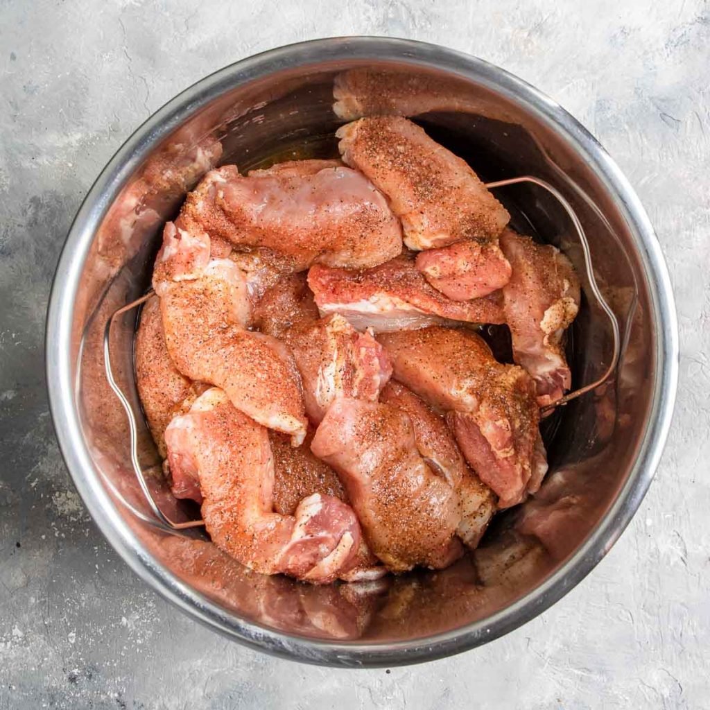 Country style ribs coated in seasoning and in the Instant Pot