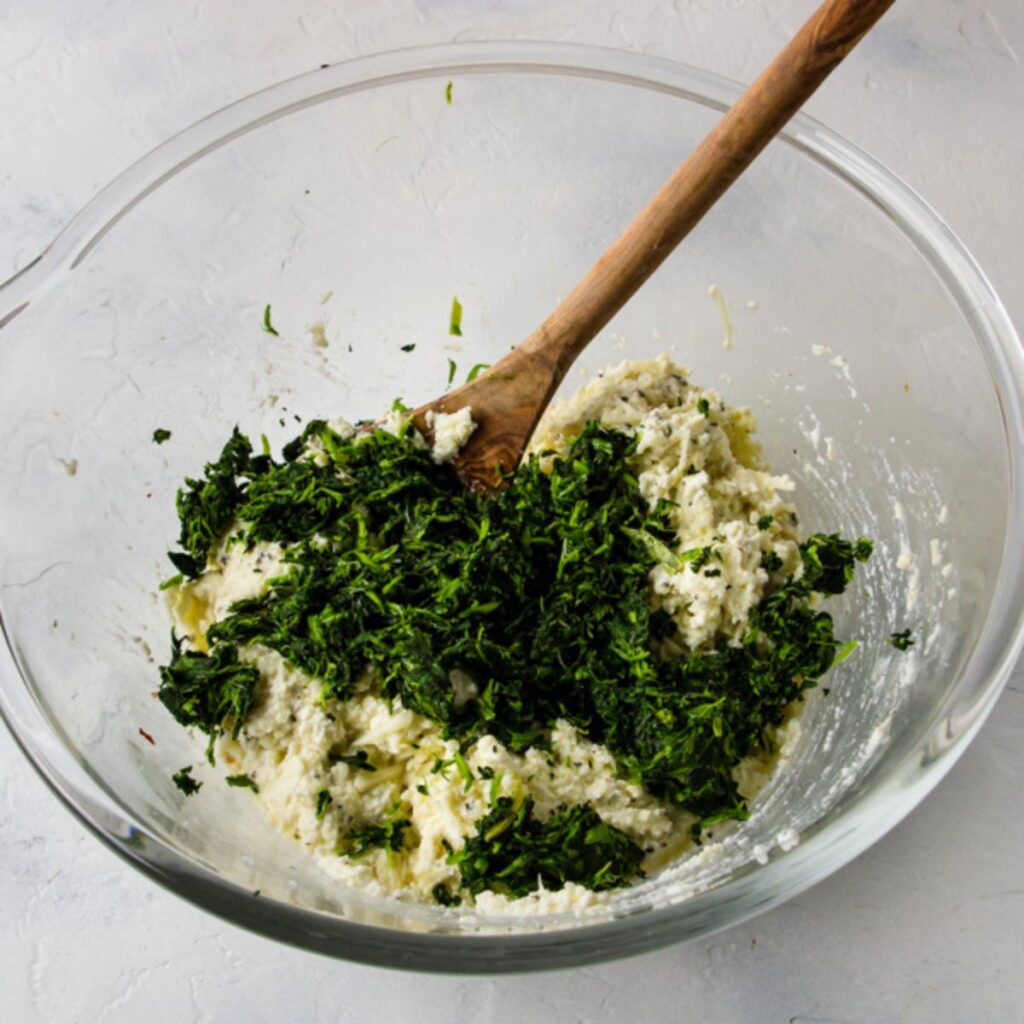 drained spinach crumbled into the filling for stuffed shells