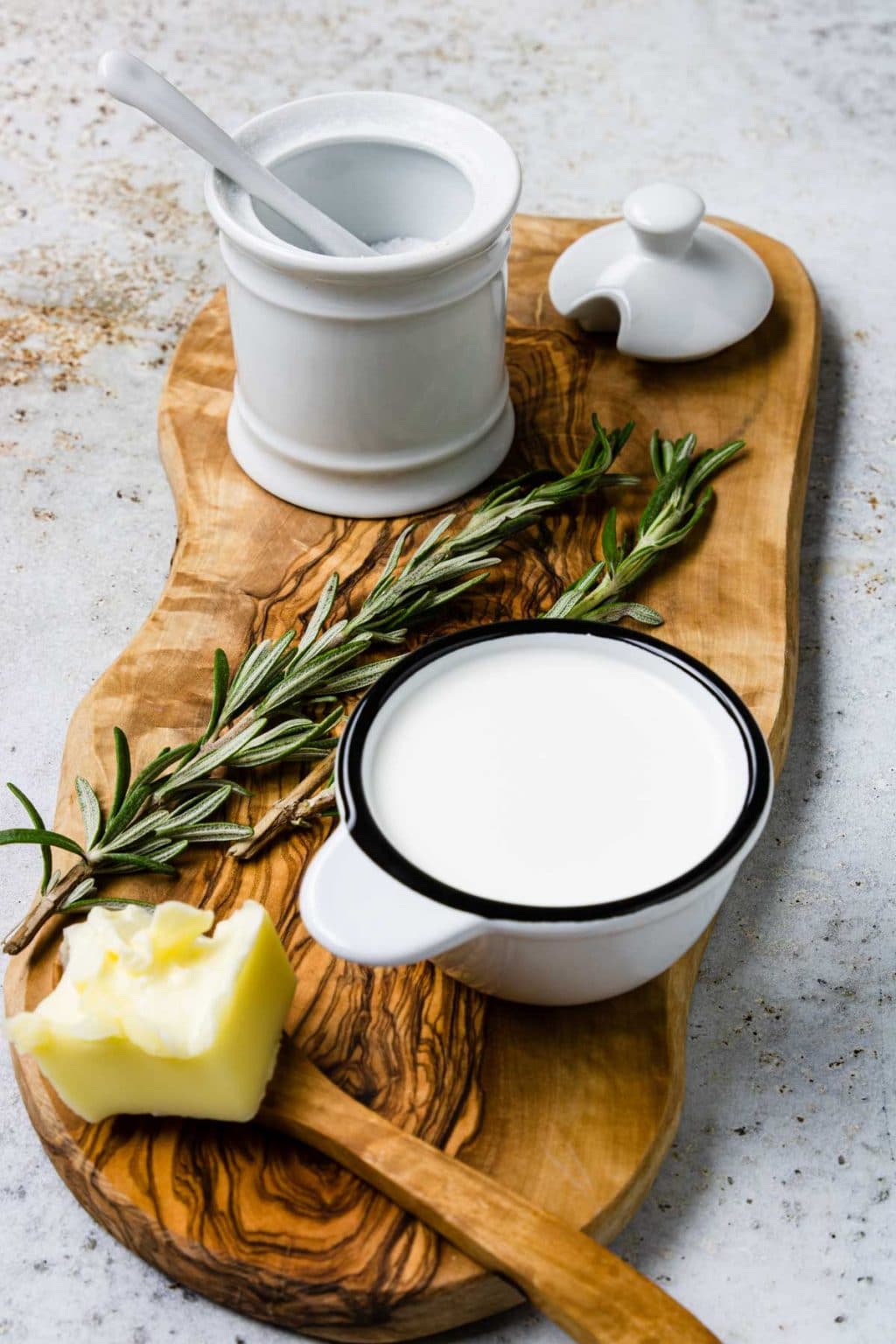 4 of the ingredients in cauliflower puree: Butter, half and half, salt, and rosemary 