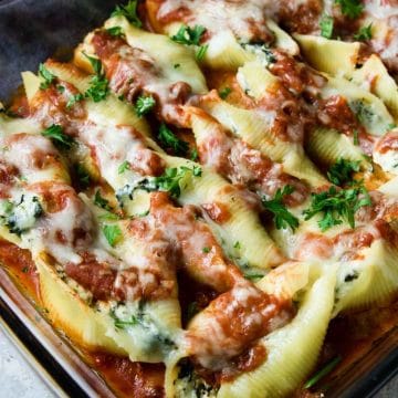 Ricotta and Spinach Stuffed Shells cooked in a glass 9x13 dish topped with cheese and sauce