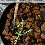 Garlic Butter Steak Bites in a skillet with pinterest text over the image