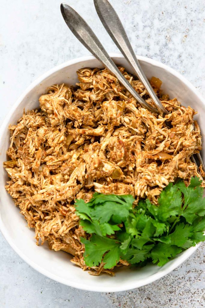 Shredded Instant Pot Chicken Tacos garnished with cilantro