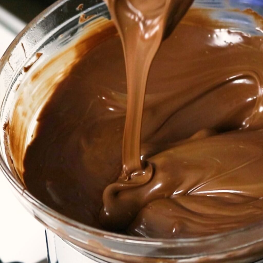 Chocolate and white chocolate melting wafers melted together in a double boiler 