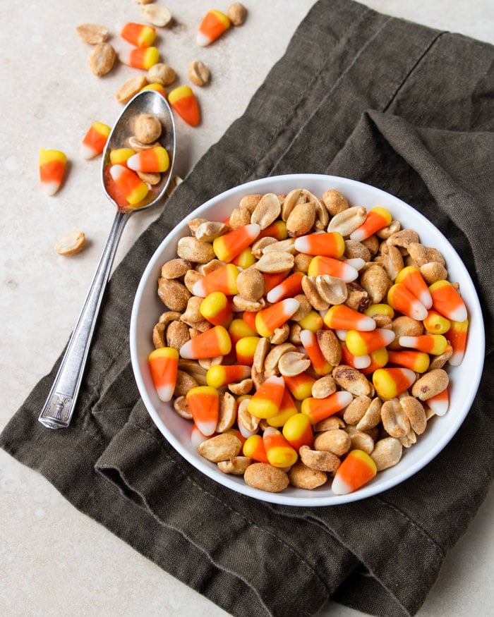 Candy Corn and Peanuts mixed in a white bowl