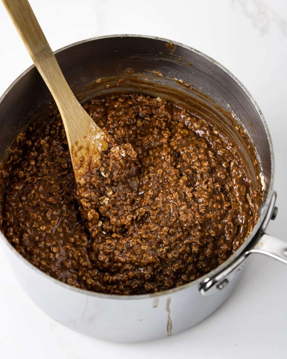 no bake cookie mixture in a pot with a wooden spoon