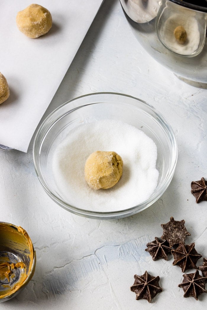 Rolling peanut butter cookie dough in sugar