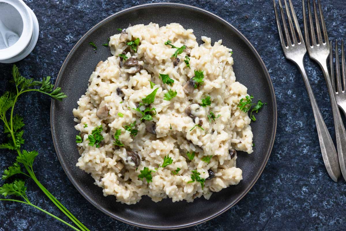 risotto with mushrooms on a plate with parsley