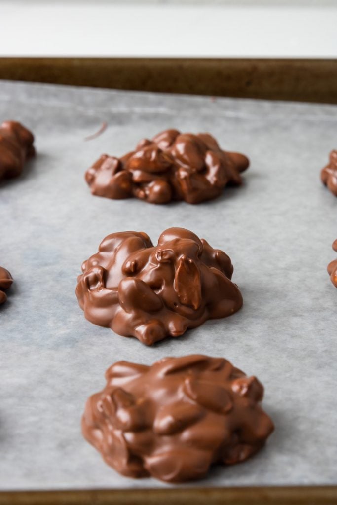 Chocolate Peanut Clusters on wax paper