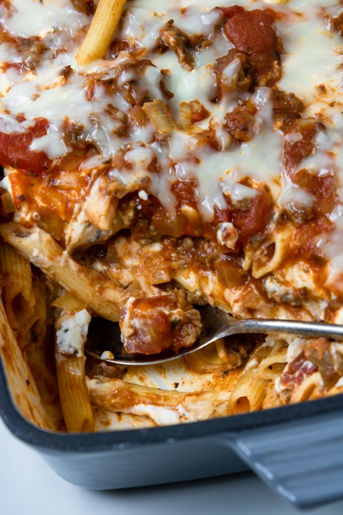 Spooning out the baked penne pasta recipe 