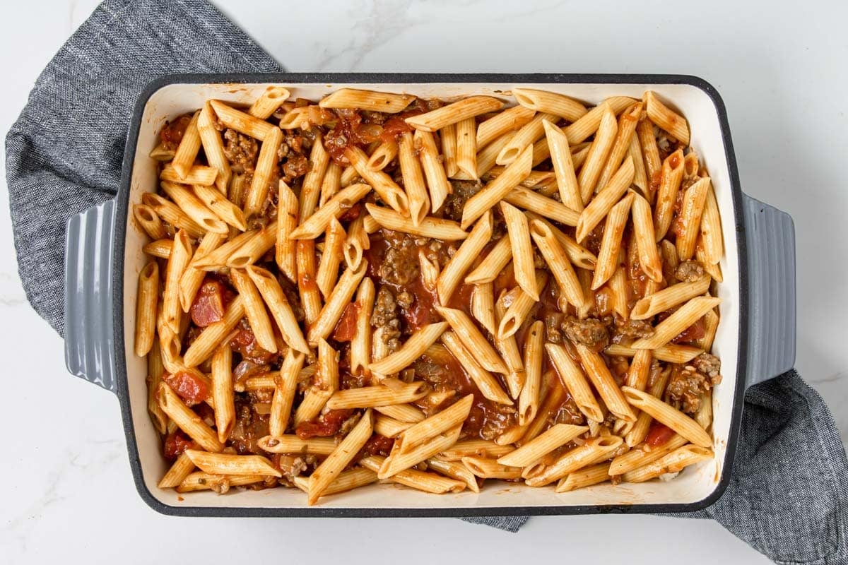 penne pasta with sausage marinara over top