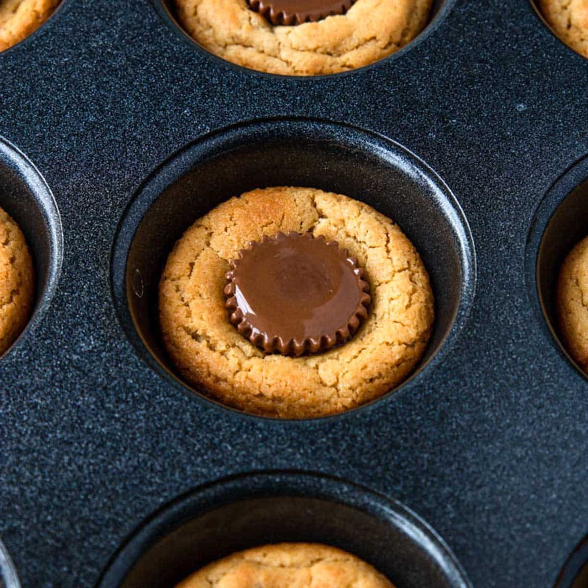 a photo of a Reece's peanut butter cup in a muffin tin