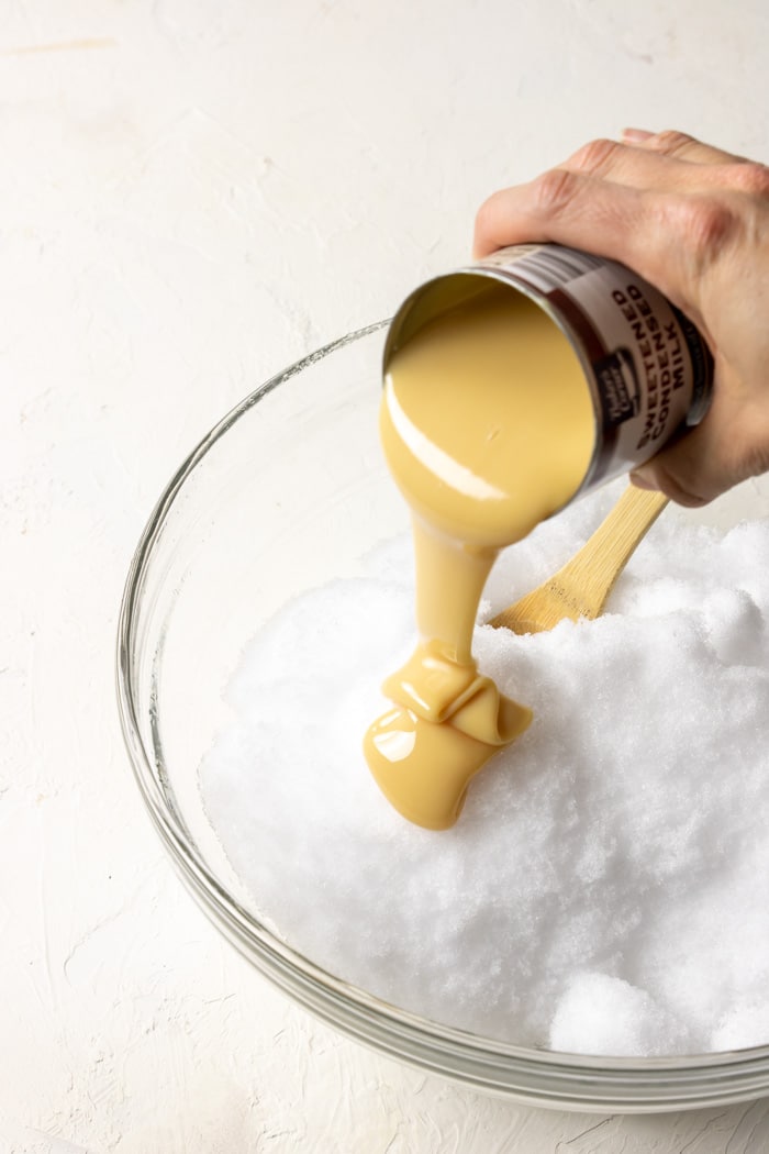 condensed milk being poured over snow