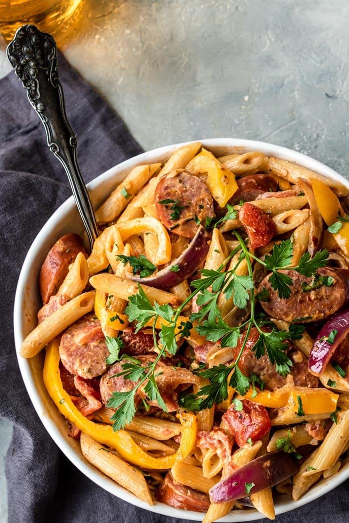 cajun pasta with peppers and sausage topped with parsley