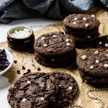 Hot cocoa cookies in stacks on brown parchment paper