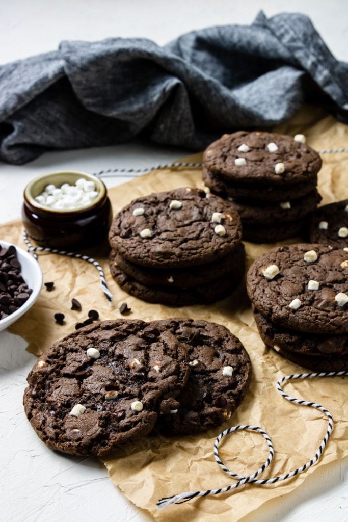 Hot cocoa cookies in stacks on brown parchment paper