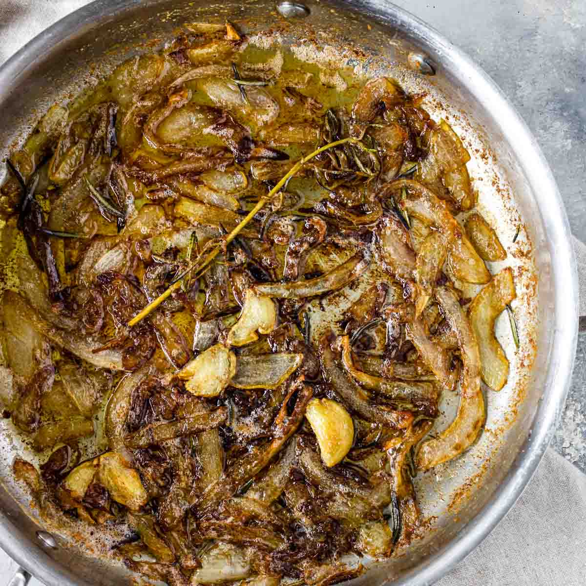 onions caramelized in a pan with garlic and rosemary