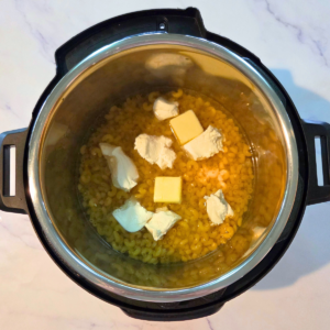 water, macaroni, butter, cream cheese and water in the instant pot