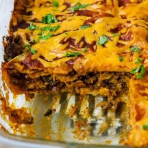 Beef enchilada casserole with a slice cut out.