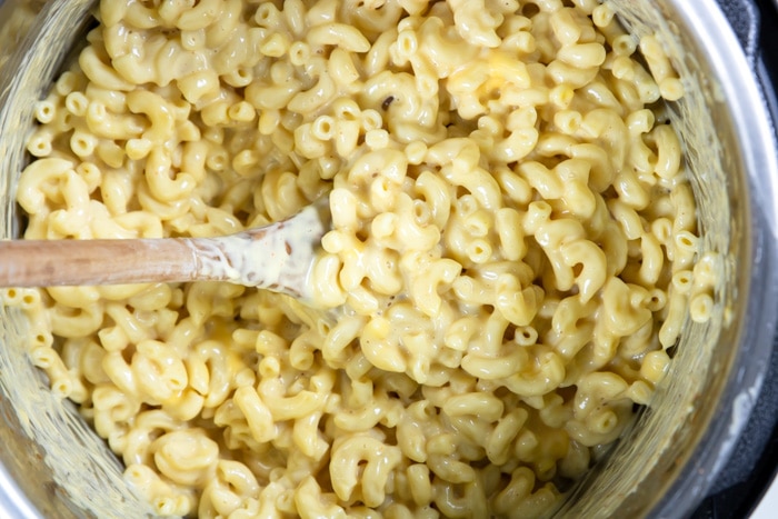 Creamy and Cheesy mac and cheese on a spoon in the instant pot