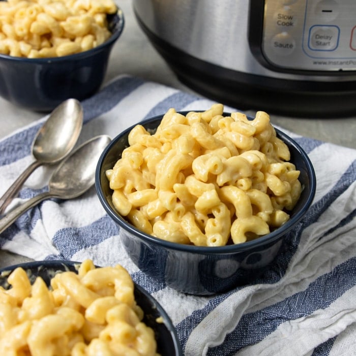 Instant pot and three bowls of mac and cheese