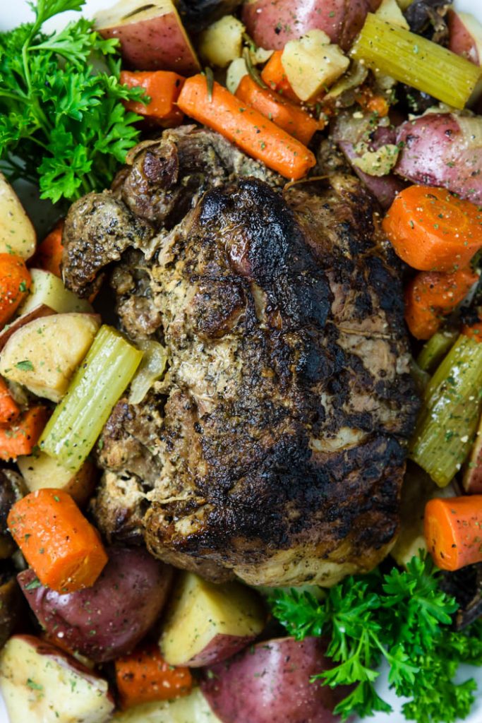 Instant Pot Pork roast surrounded by veggies on a platter