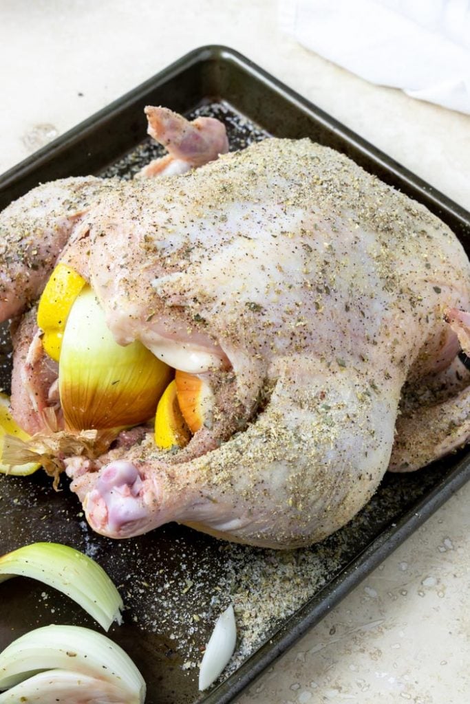 rotisserie chicken seasoned with herbs and spices and stuffed with onions and lemons