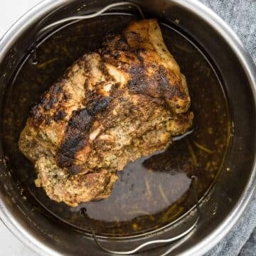 a pork roast that has been browned and is in the Instant Pot to be cooked