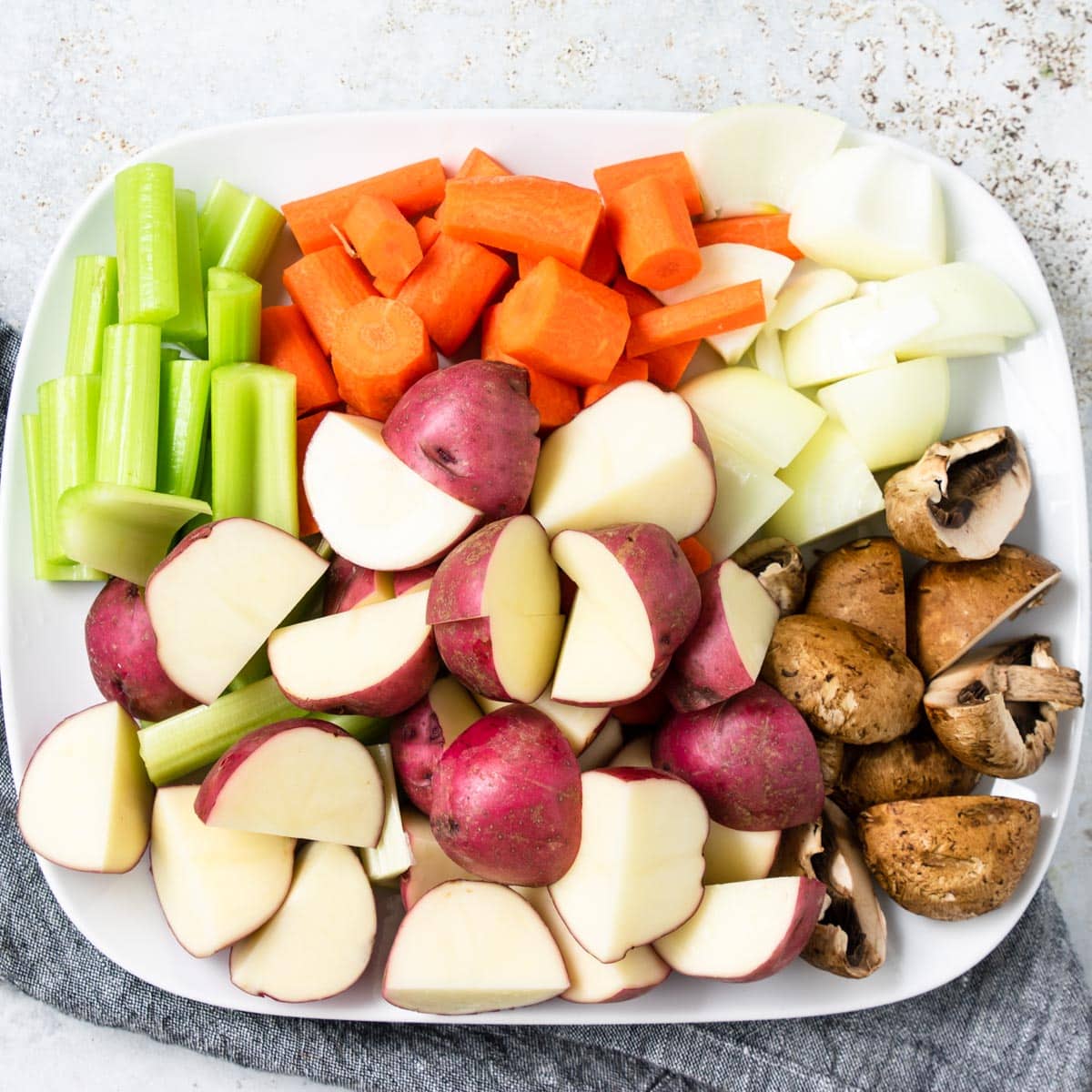 platter of vegetables that have been cut and ready for cooking