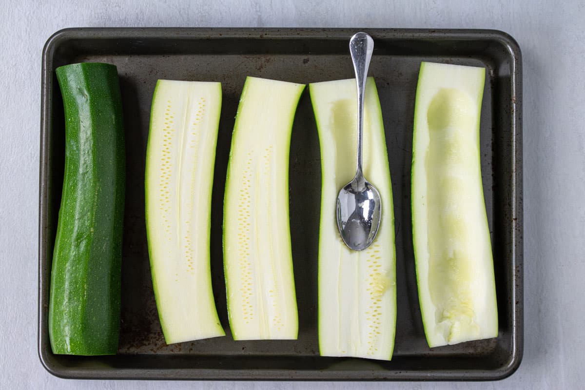 showing how to make zucchini boats by hollowing out the center