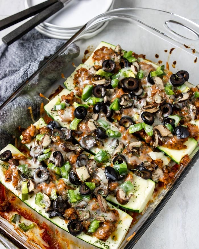 zucchini pizza boats in a glass casserole dish