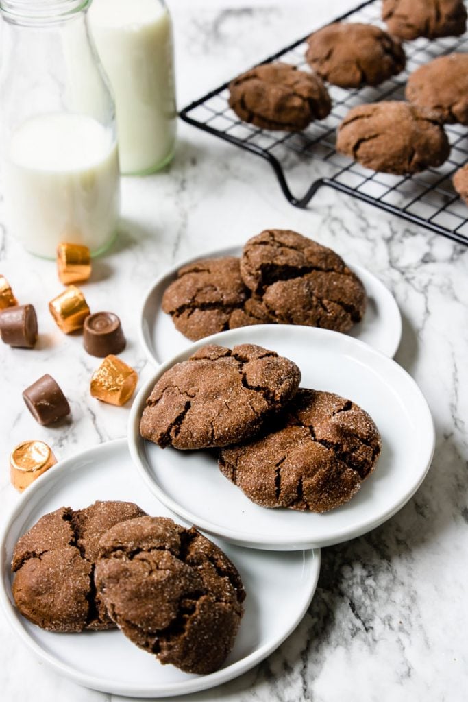 Chocolate Rolo Cookies on white plates and on a cooling rack