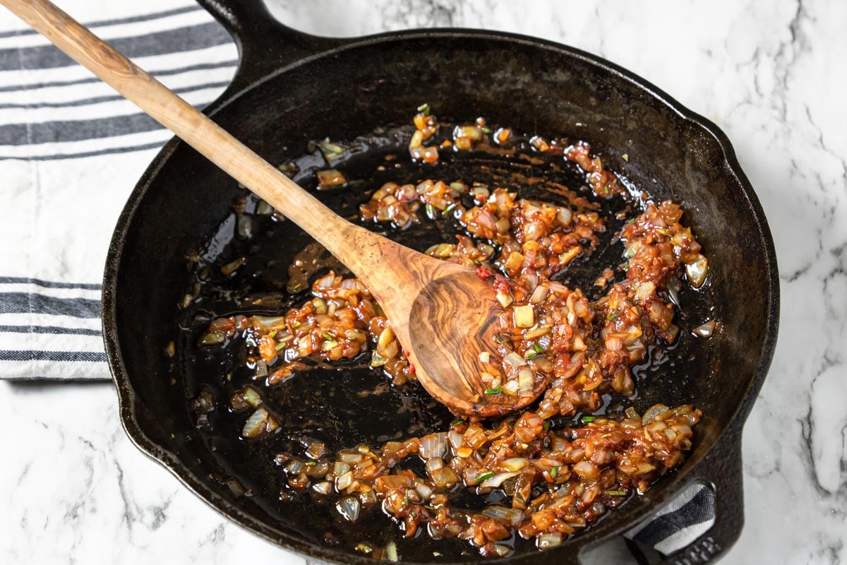 onions and garlic in a skillet coated with worcestershire and tomato paste