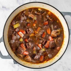 a large pot of red wine beef stew ready to serve