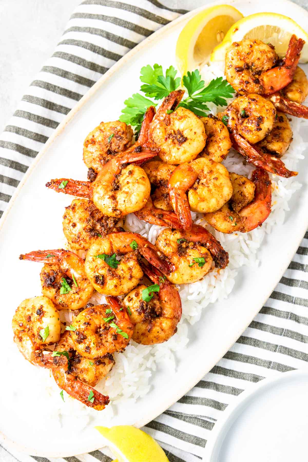 Skillet Cajun Shrimp served on a plate over white rice