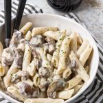 penne coated in a cream sauce with mushrooms.