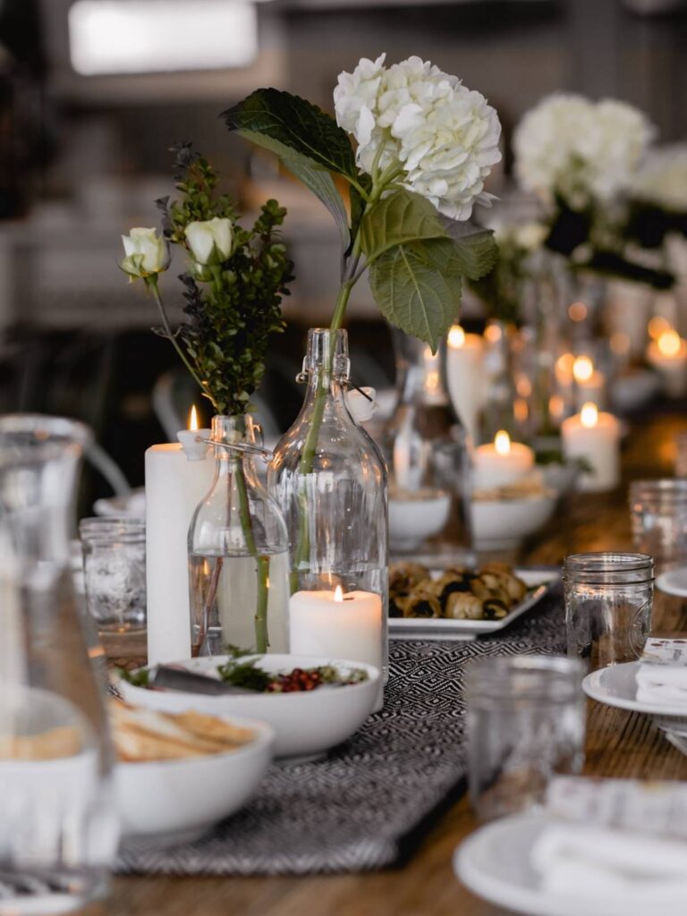 a table with white and green flowers down the middle