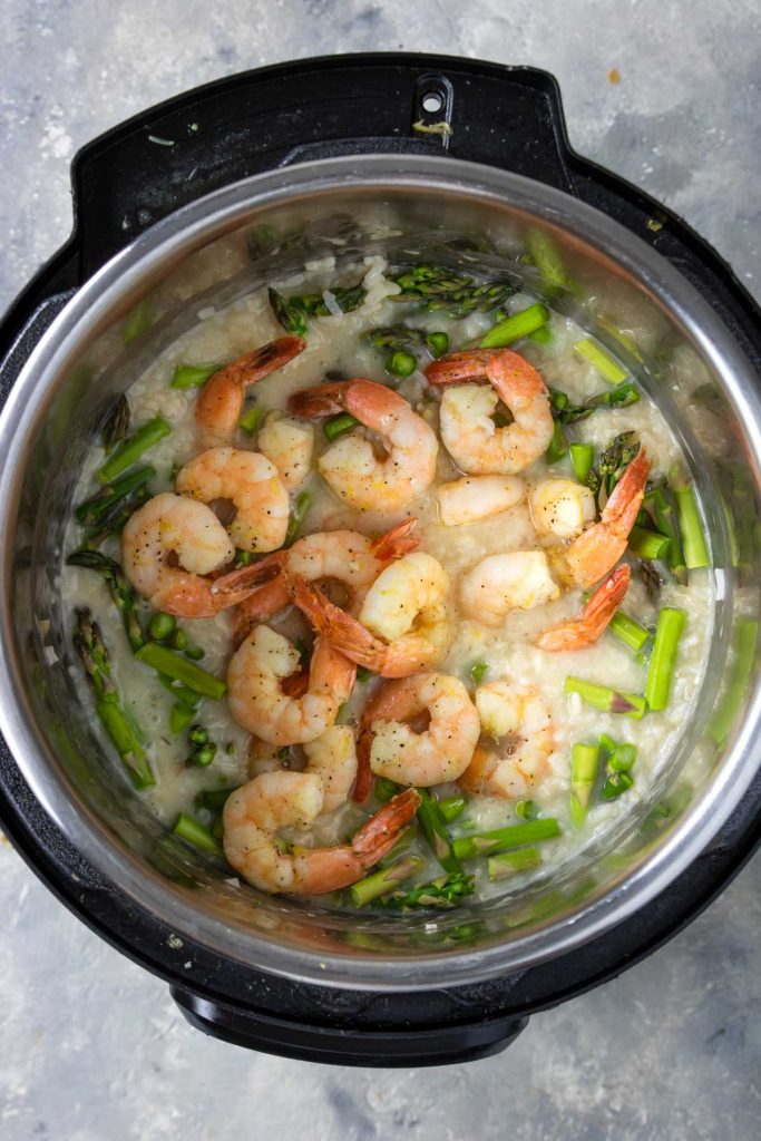 marinated and sauteed shrimp on top of risotto and asparagus in the Instant Pot