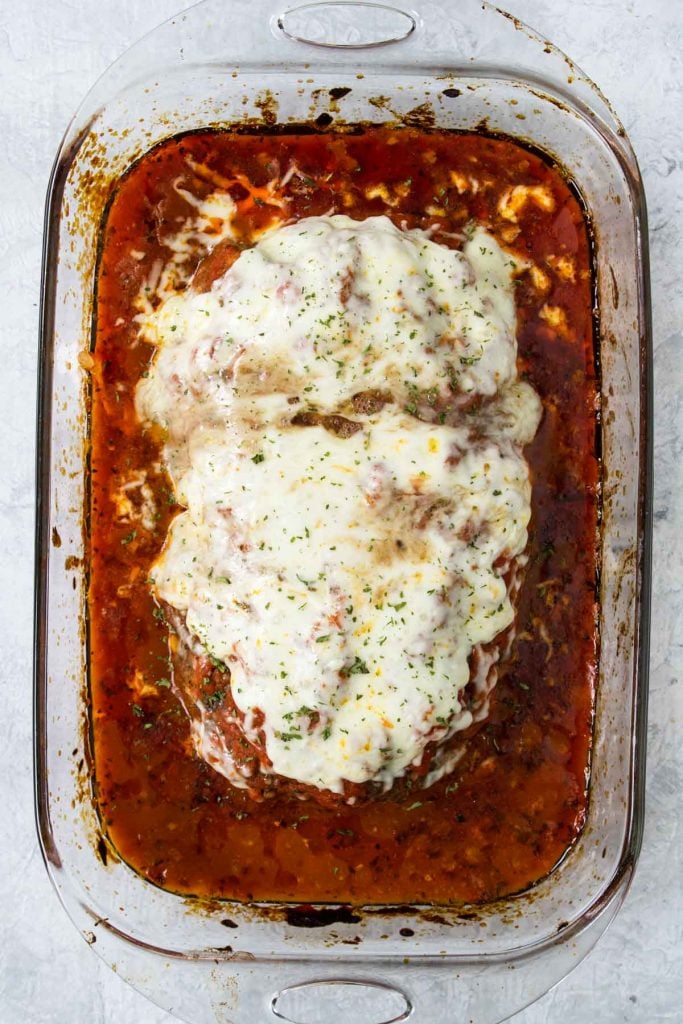 Italian Meatloaf in a baking dish covered in marinara and cheese