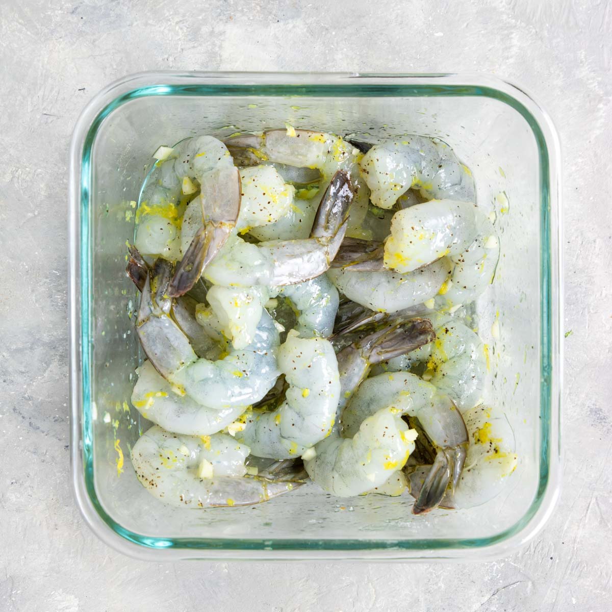 shrimp marinating in garlic, lemon and olive oil