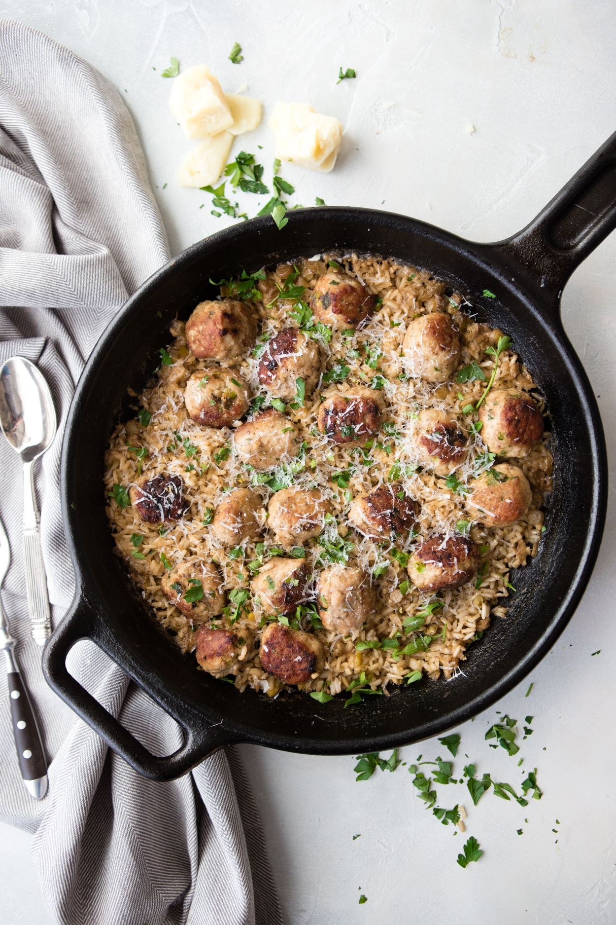 cast iron skillet with rice and meatballs