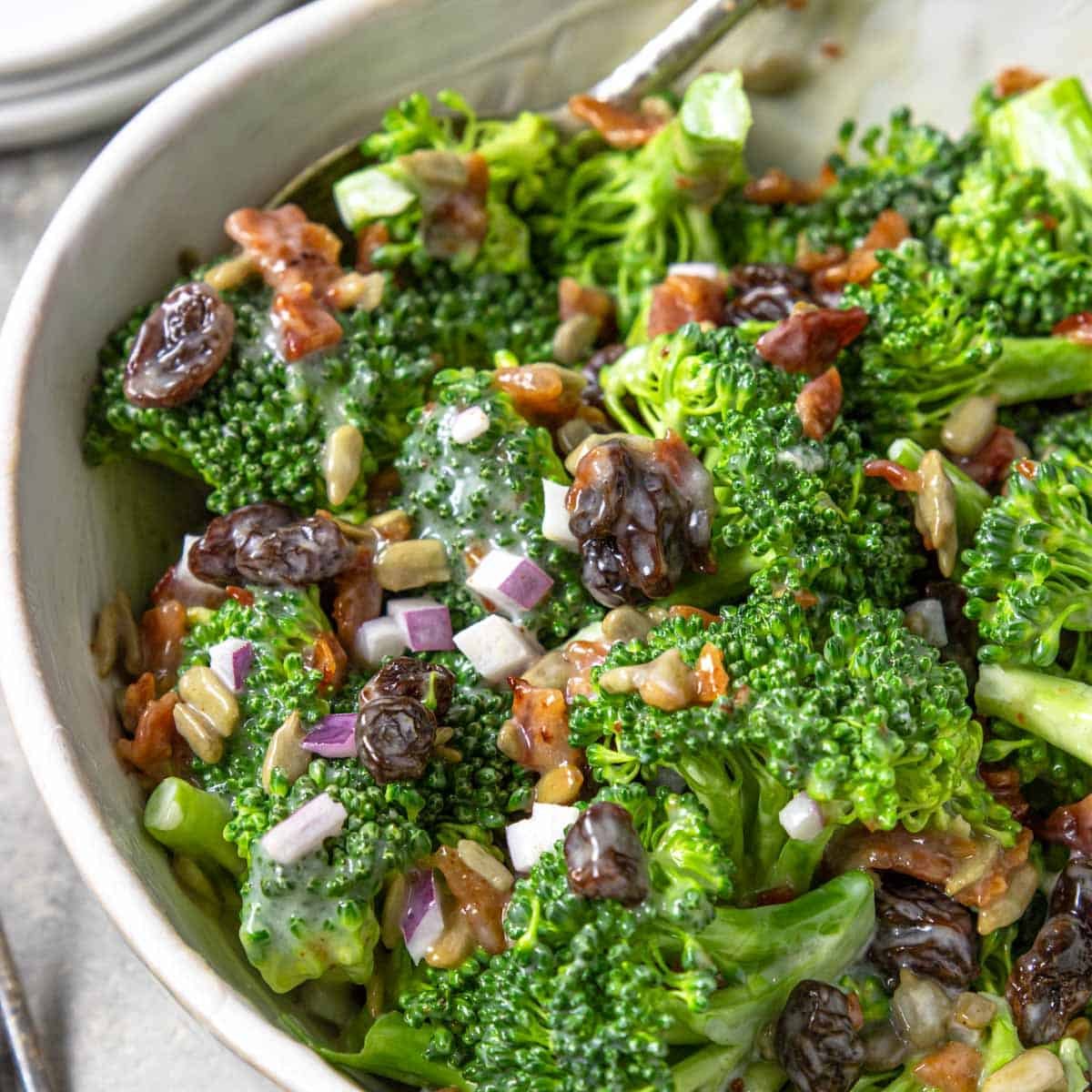 broccoli bacon salad in a white bowl