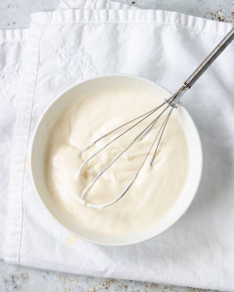 cajun aioli whisked together in a white bowl