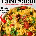 taco salad topped with fritos and text overlay for Pinterest