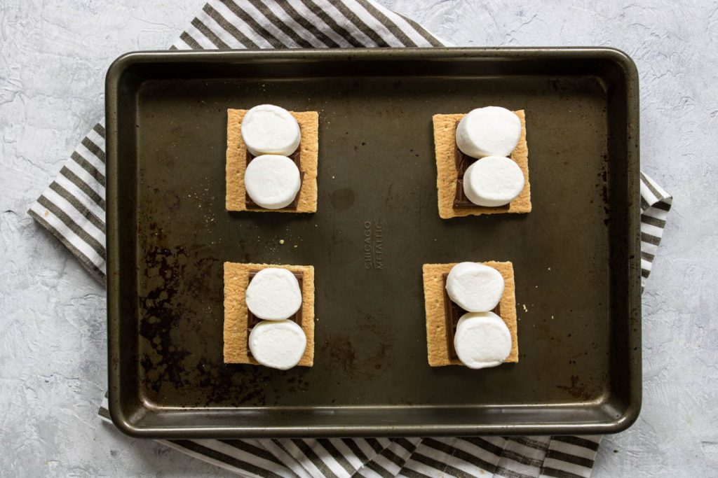 graham crackers topped with hershey bars and marshmallows