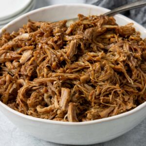 Instant Pot pulled pork in a white bowl