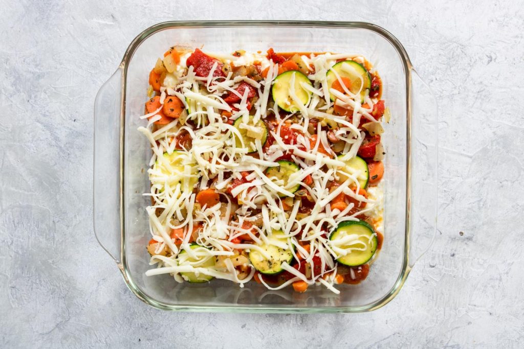 Layering Veggie Lasagna - noodles, cottage cheese, sauce, veggies and cheese