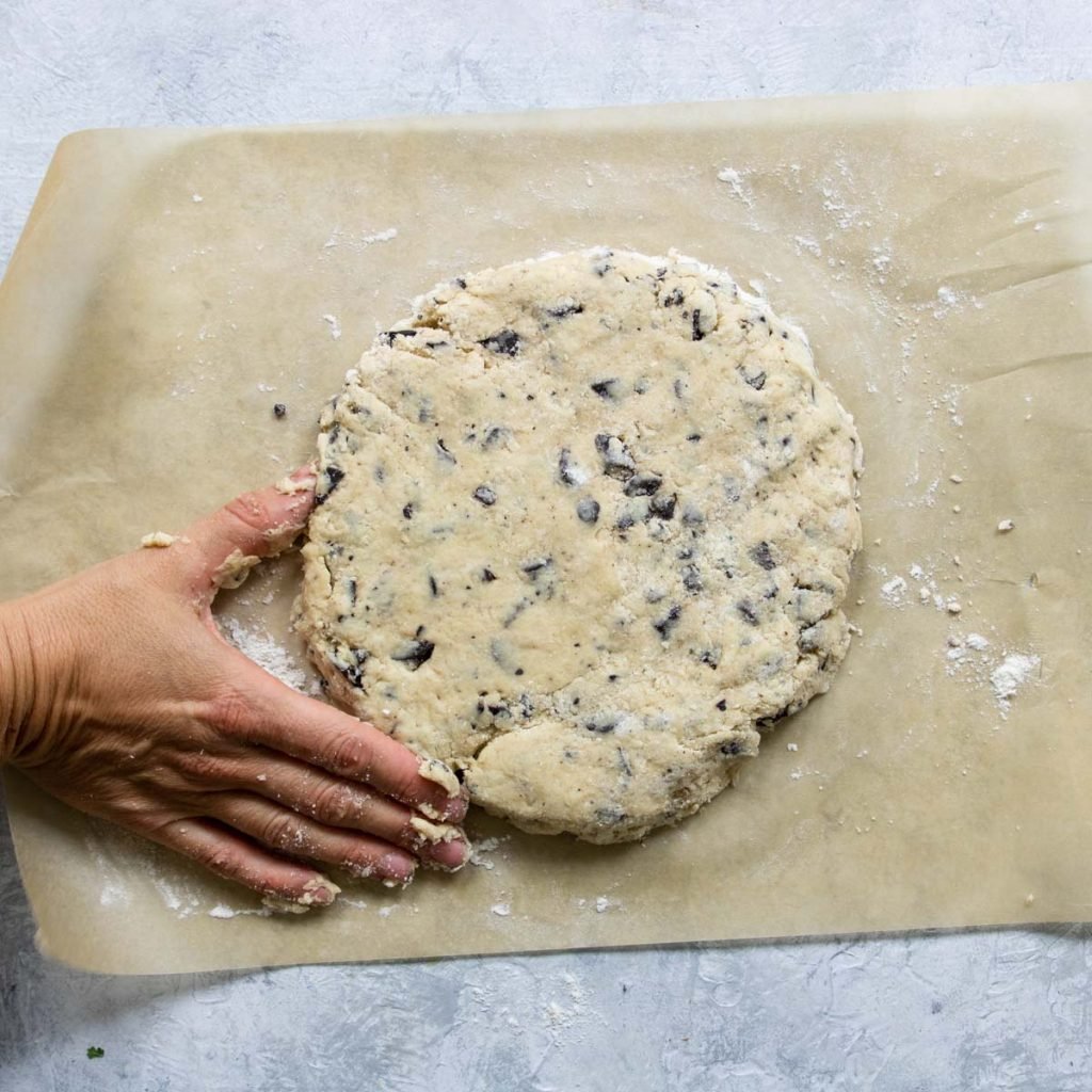 making a ½ inch thick and 8 inch round disc of chocolate chip scone dough