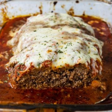 Italian Meatloaf in a pan, with one slice cut